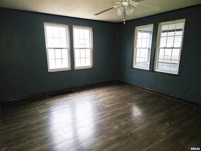 empty room featuring ceiling fan and dark hardwood / wood-style floors