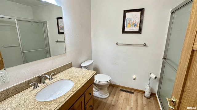 1807 E Saint Louis St, West Frankfort, IL 62896 - full bathroom with wood finished floors, a stall shower, and vanity