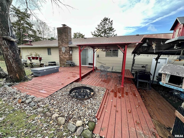 1807 E Saint Louis St, West Frankfort, IL 62896 - back of house with a wooden deck, a chimney, and an outdoor fire pit