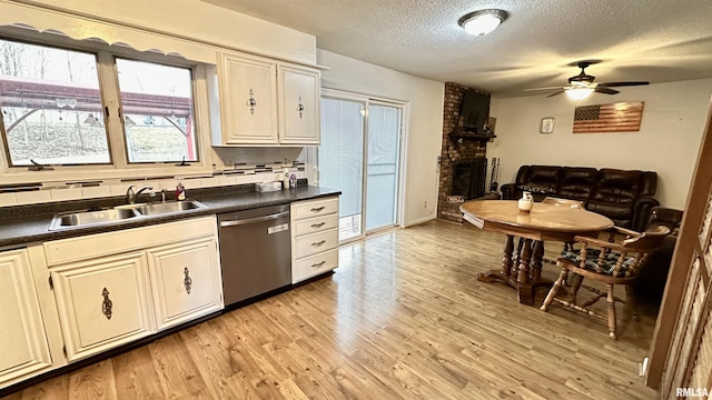 1807 E Saint Louis St, West Frankfort, IL 62896 - kitchen featuring dishwasher, a textured ceiling, a fireplace, a ceiling fan, and dark countertops