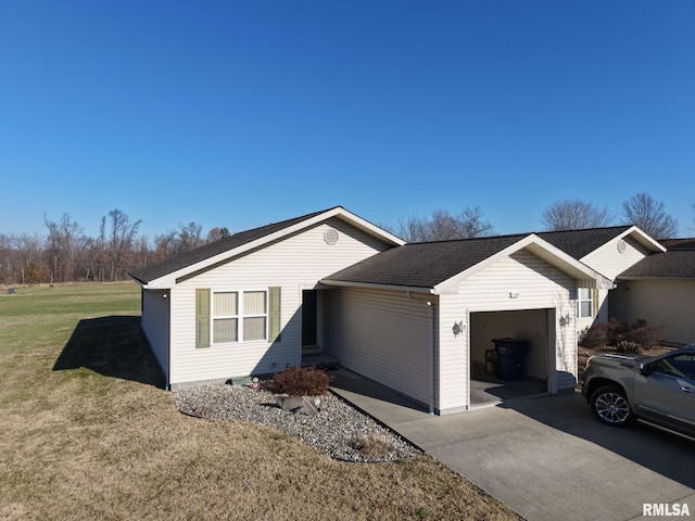 ranch-style house featuring a garage and a front lawn