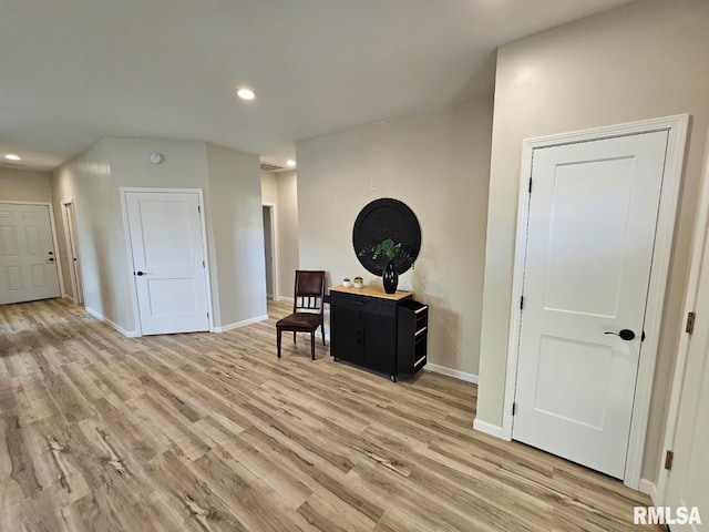 living area with recessed lighting, baseboards, and light wood-style floors