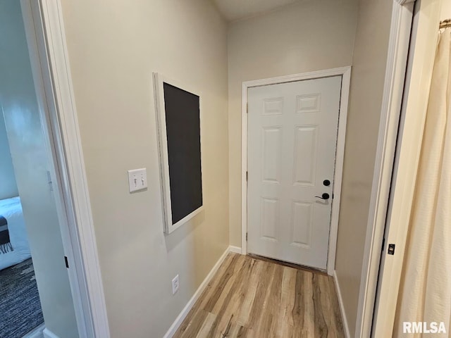 entryway featuring baseboards and light wood finished floors