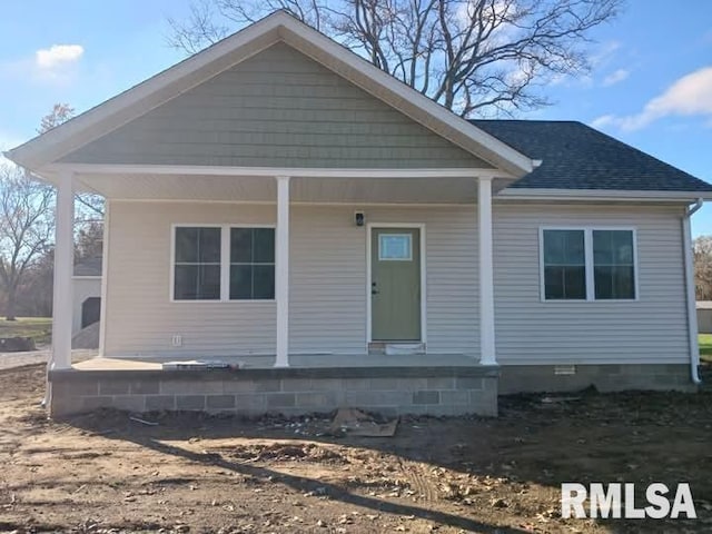 view of front of house with a porch, roof with shingles, and crawl space