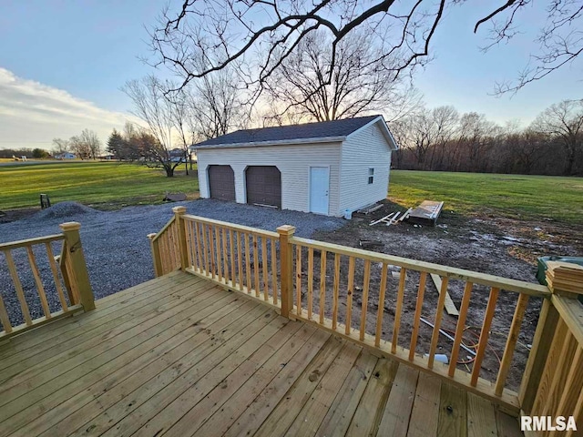 deck with an outbuilding, a yard, and a garage