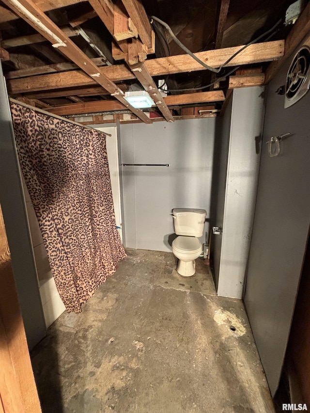 bathroom with concrete floors and toilet