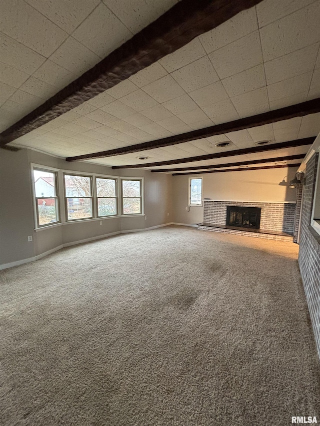 unfurnished living room featuring carpet flooring, a fireplace, and beamed ceiling