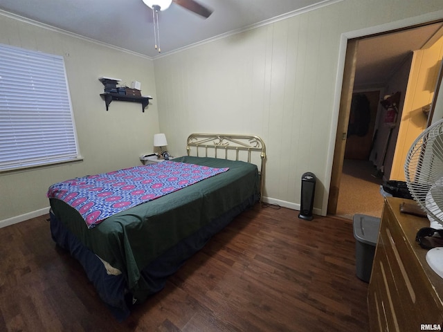 bedroom featuring dark wood-type flooring, ceiling fan, and ornamental molding