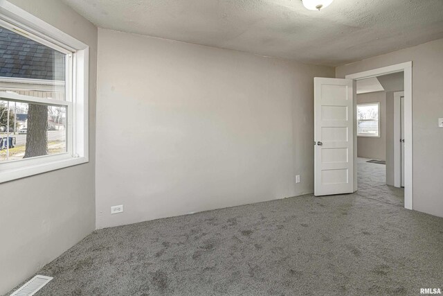 unfurnished bedroom with light colored carpet and connected bathroom