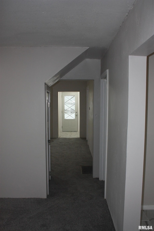 hallway with dark colored carpet