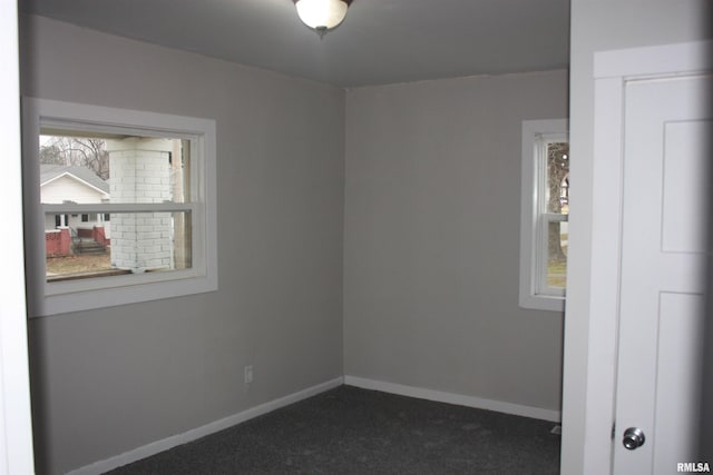 empty room with dark colored carpet