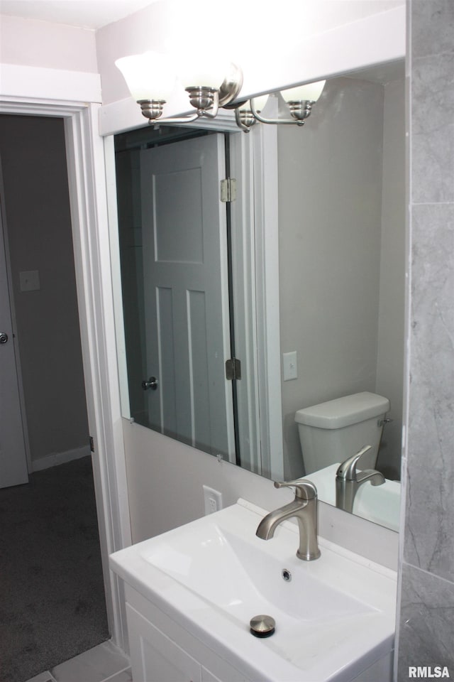 bathroom with tile patterned flooring, a notable chandelier, toilet, and sink