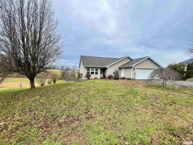 ranch-style house with a front yard and a garage