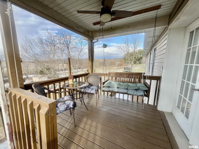 wooden deck featuring ceiling fan