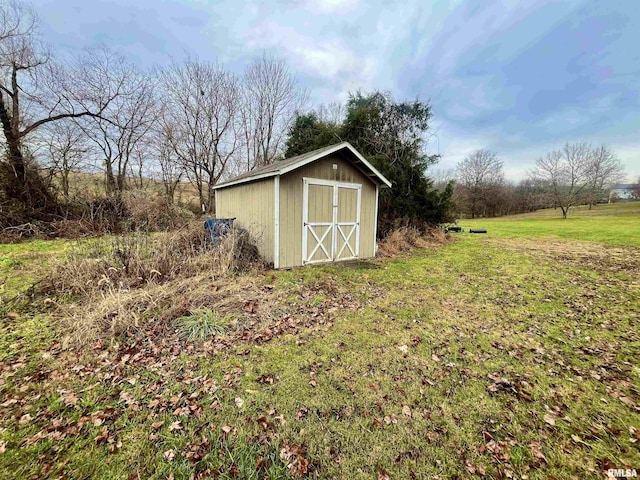 view of outbuilding with a yard