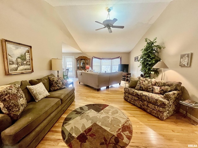 living room featuring high vaulted ceiling, light hardwood / wood-style flooring, and ceiling fan