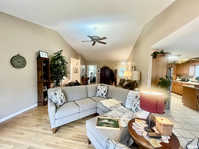 living room with light hardwood / wood-style flooring, ceiling fan, and lofted ceiling