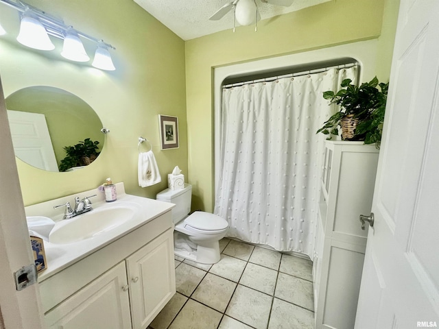 bathroom featuring vanity, a textured ceiling, ceiling fan, tile patterned flooring, and toilet