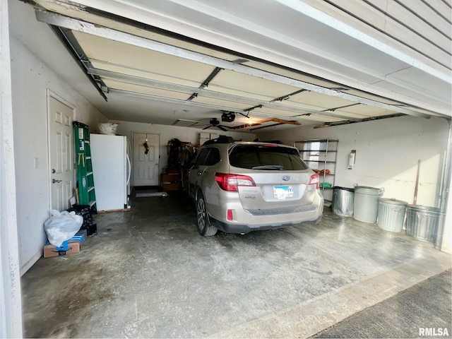 garage with white refrigerator and a garage door opener