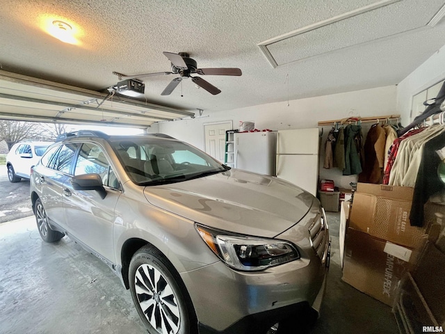 garage with ceiling fan, a garage door opener, and white refrigerator