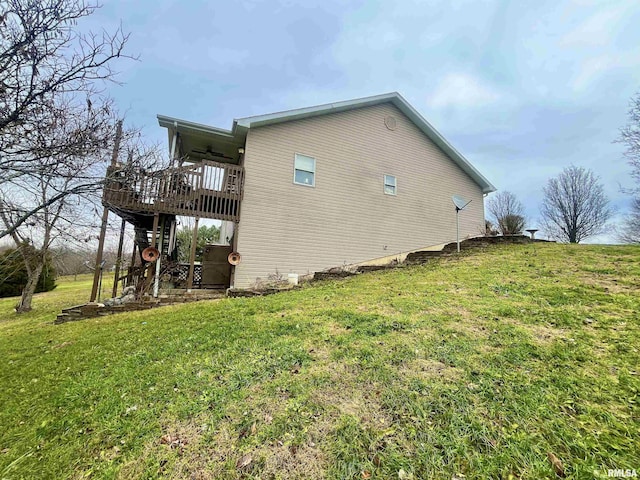 view of property exterior featuring a yard and a wooden deck