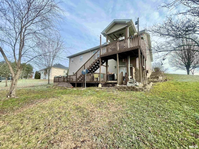 back of property with a lawn and a deck