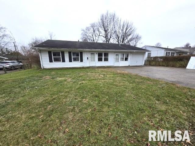 single story home featuring a front lawn and a garage