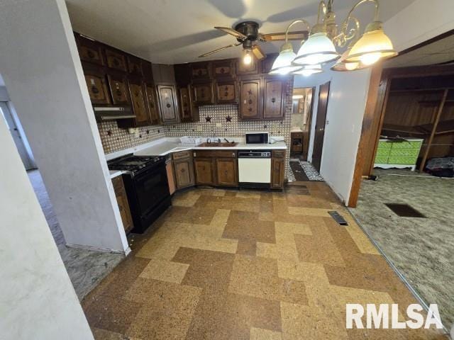 kitchen with tasteful backsplash, dark brown cabinets, black appliances, hanging light fixtures, and range hood