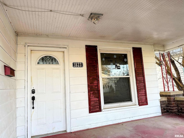 view of exterior entry featuring concrete block siding