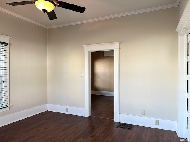 unfurnished room featuring visible vents, ornamental molding, and dark wood-style flooring