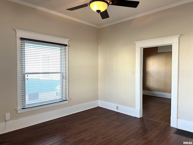 spare room featuring ornamental molding, dark wood finished floors, baseboards, and ceiling fan