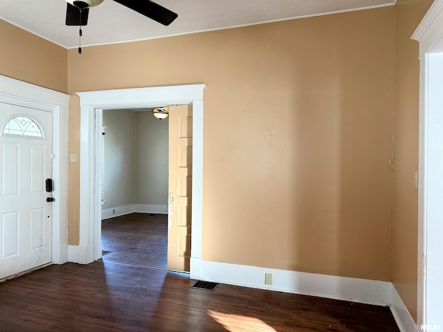 entrance foyer with dark wood-style floors, ceiling fan, visible vents, and baseboards