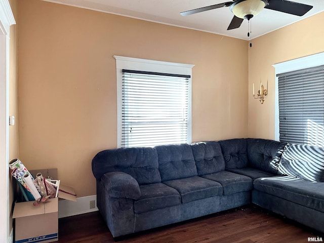 living area with ceiling fan and dark wood finished floors