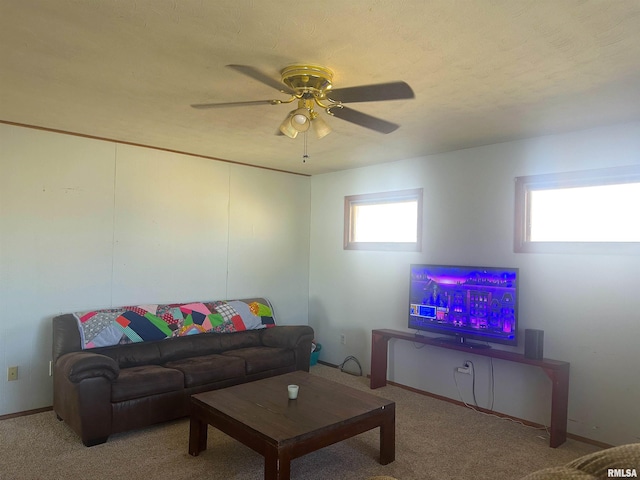 living room with a textured ceiling, light colored carpet, and ceiling fan