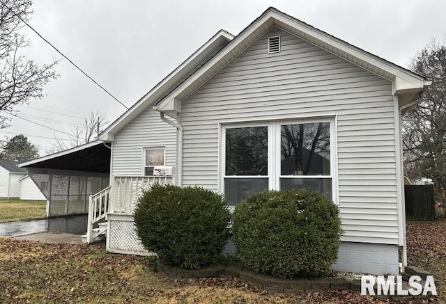 view of side of home featuring a carport