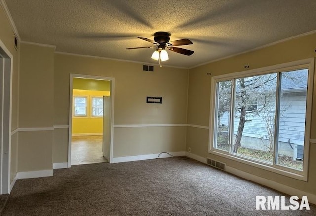 spare room with ceiling fan, crown molding, and light carpet