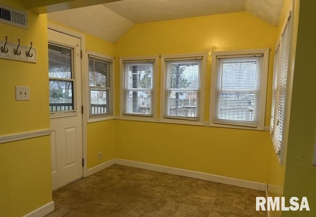 unfurnished sunroom featuring a wealth of natural light and lofted ceiling