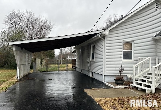 view of side of property with a carport