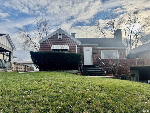 427 E Main St, Salem, IL 62881 - view of front facade with fence, a front yard, brick siding, and a chimney