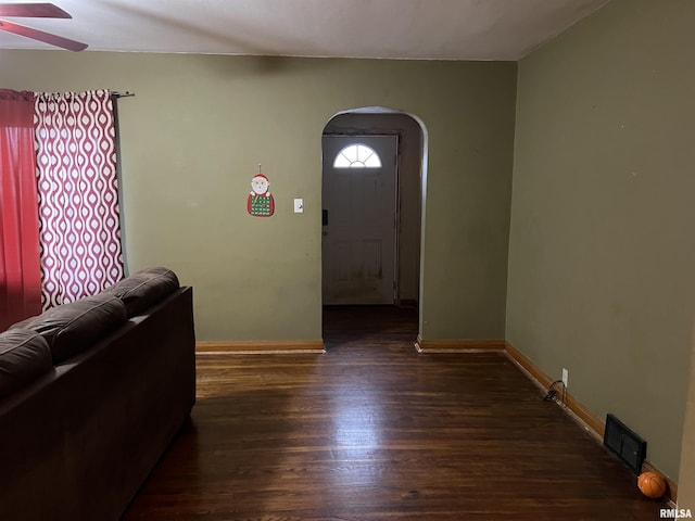 foyer entrance featuring ceiling fan and dark wood-type flooring