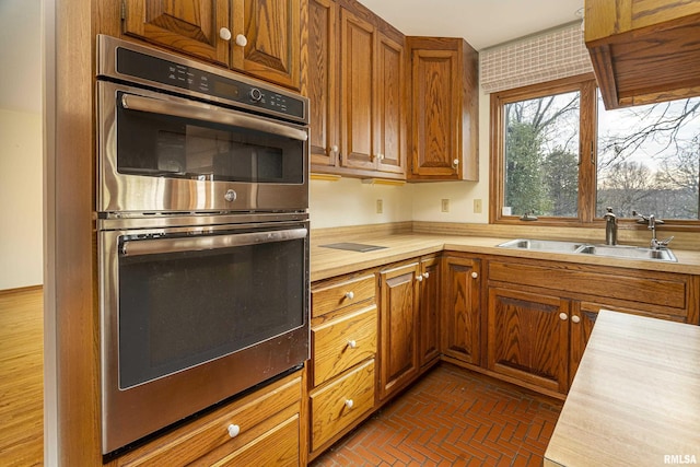 kitchen featuring stainless steel double oven and sink