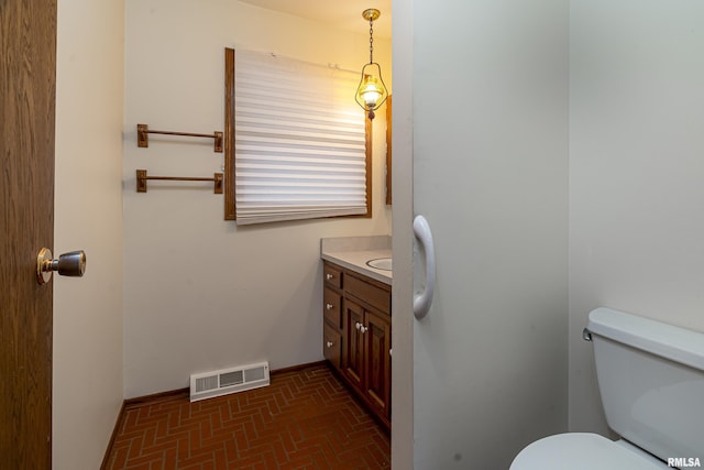 bathroom with vanity and toilet