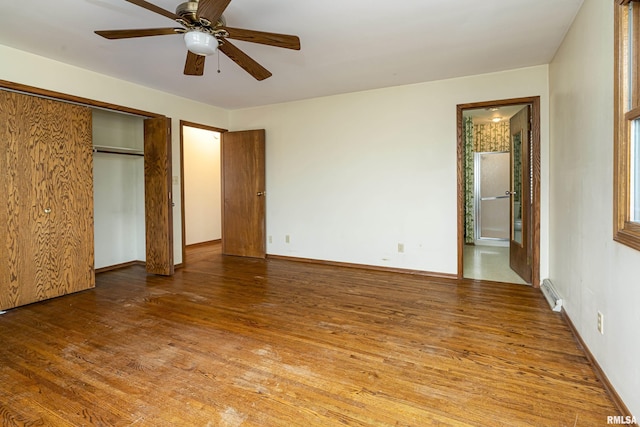 unfurnished bedroom featuring a closet, hardwood / wood-style flooring, and ceiling fan