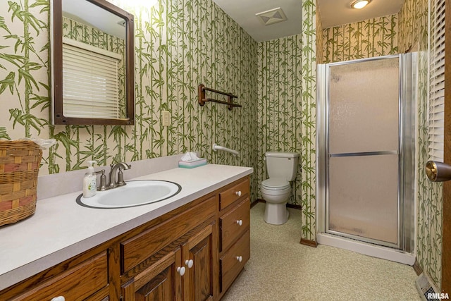 bathroom featuring a shower with door, vanity, and toilet