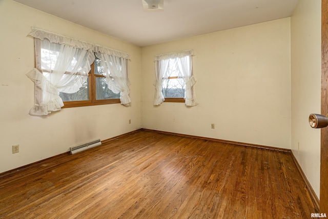 spare room featuring hardwood / wood-style floors and a baseboard radiator