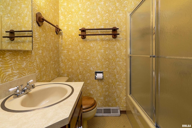 full bathroom with vanity, combined bath / shower with glass door, and toilet