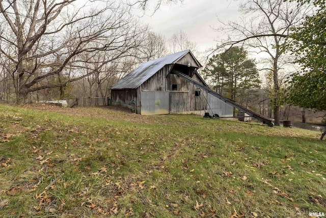 view of outbuilding with a lawn