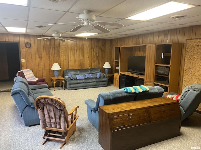 living room featuring light carpet, a paneled ceiling, and ceiling fan