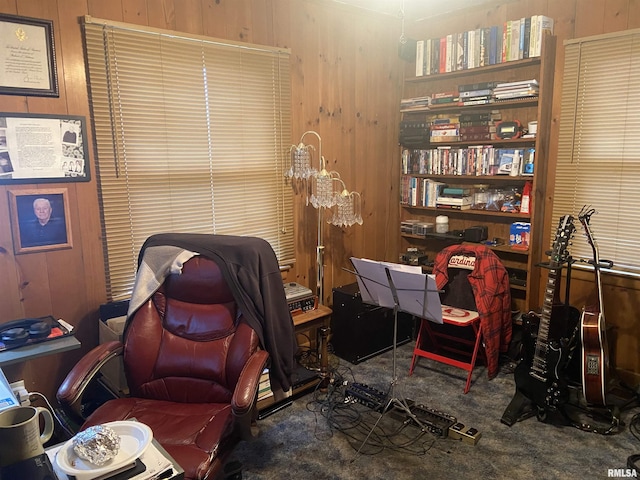 office area with carpet and wooden walls