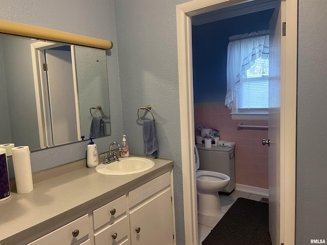 bathroom featuring tile patterned flooring, vanity, and toilet